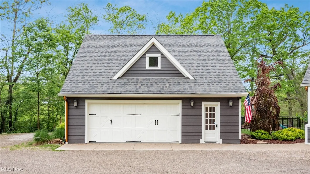 Detached garage featuring fence
