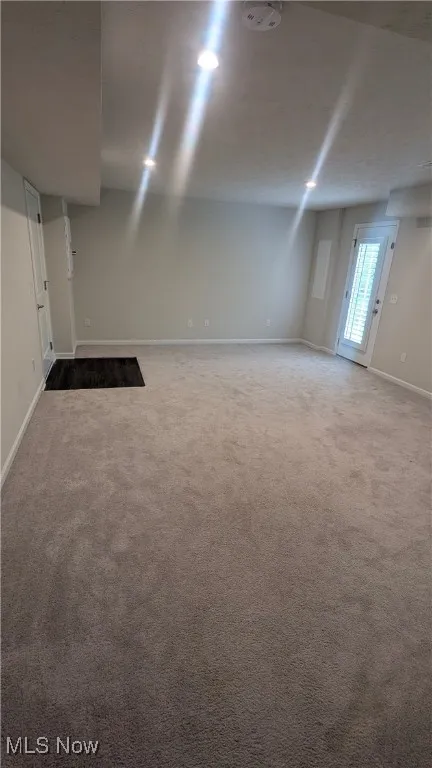 Below grade area with baseboards and carpet flooring