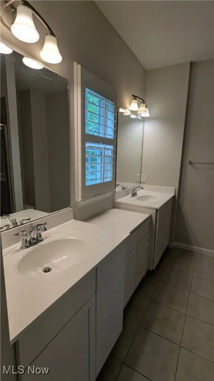 Bathroom featuring tile patterned floors and vanity