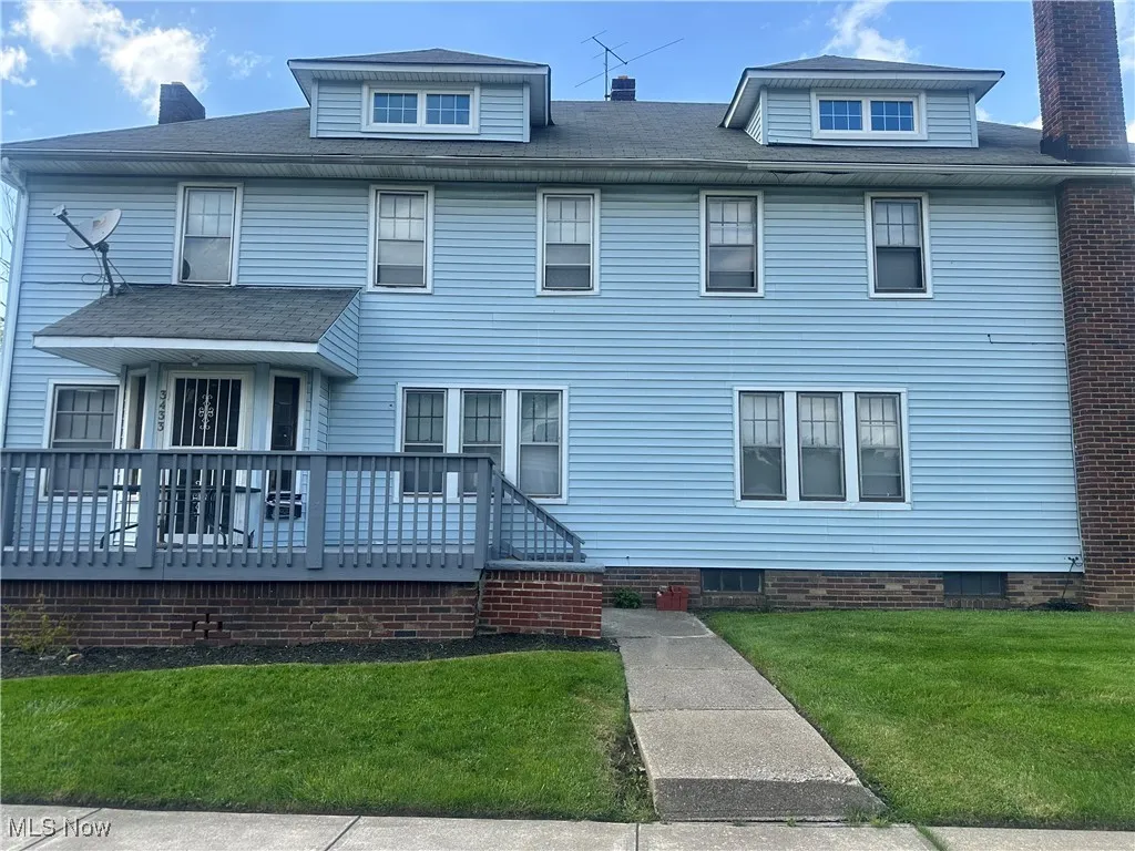 Traditional style home with a front lawn and a chimney