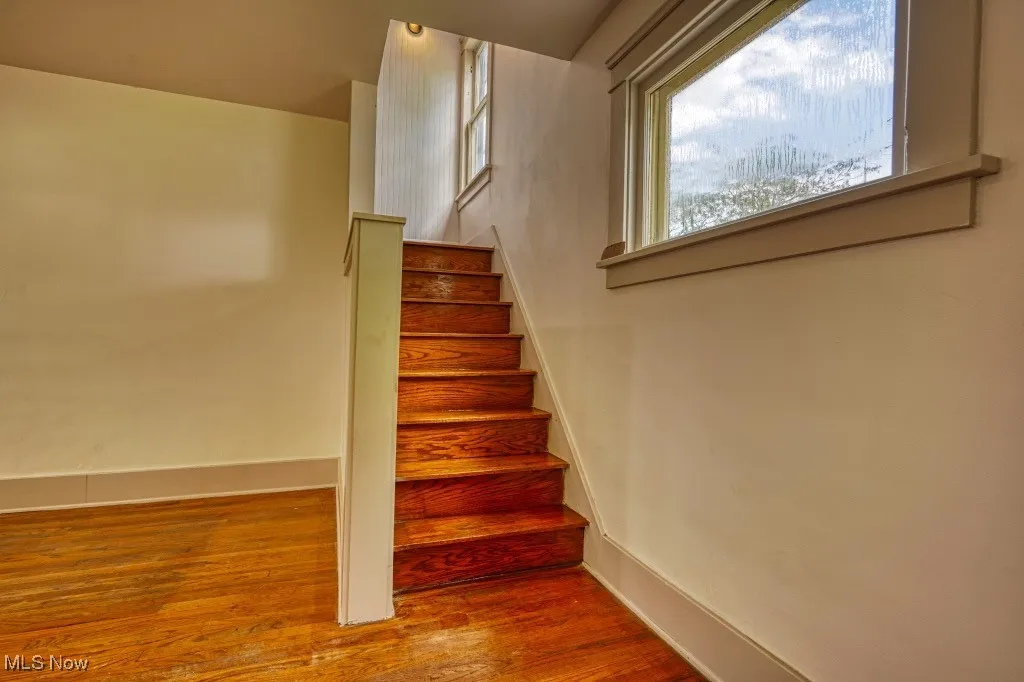 Stairs featuring baseboards and wood finished floors