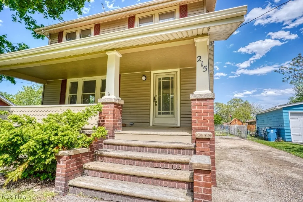 View of front facade with a porch and fence