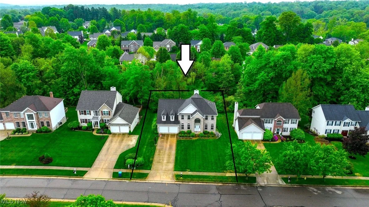 Aerial view of residential area featuring property boundaries highlighted