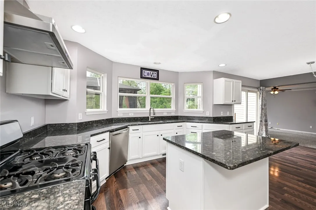 Kitchen with granite counter tops, center island and appliances