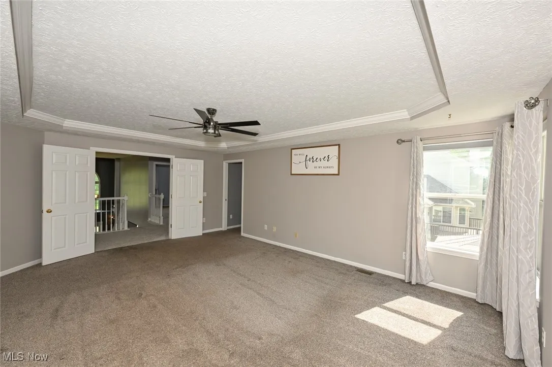 Master bedroom with tray ceilings, walk in closets and natural light