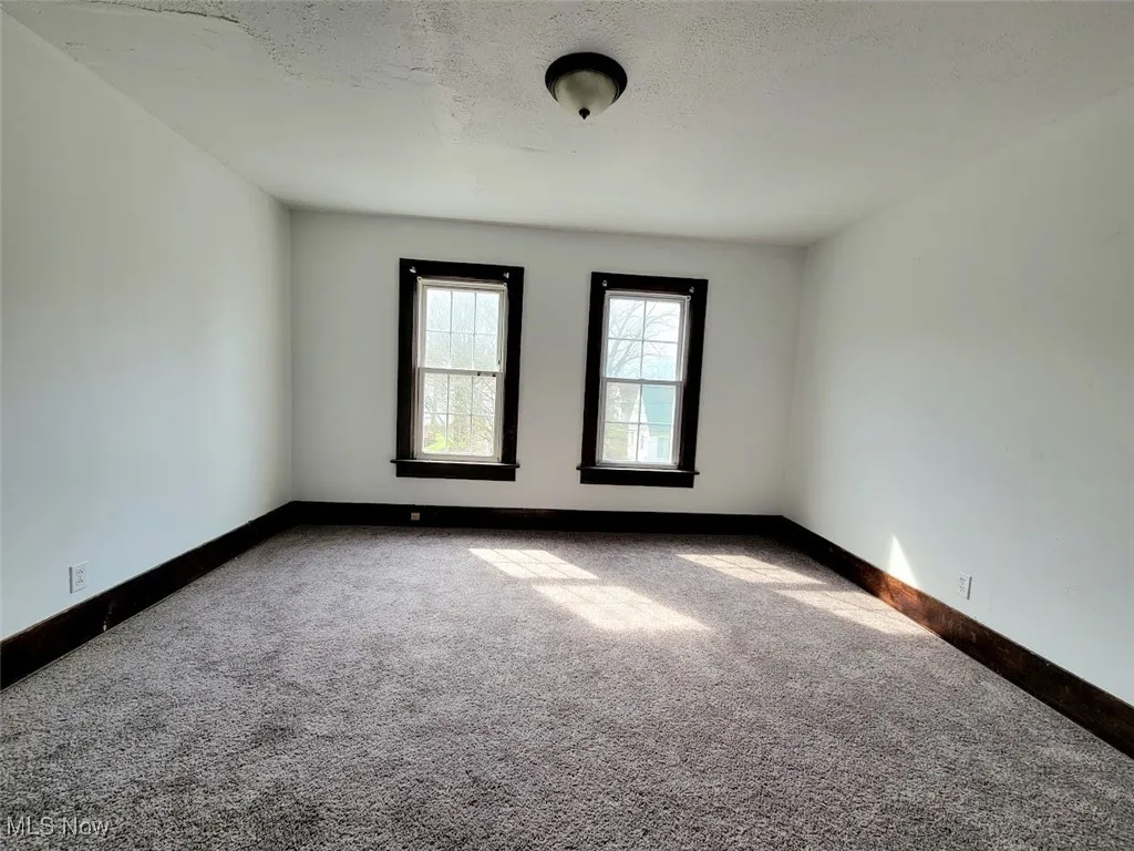 Bedroom on the second floor with carpet flooring.