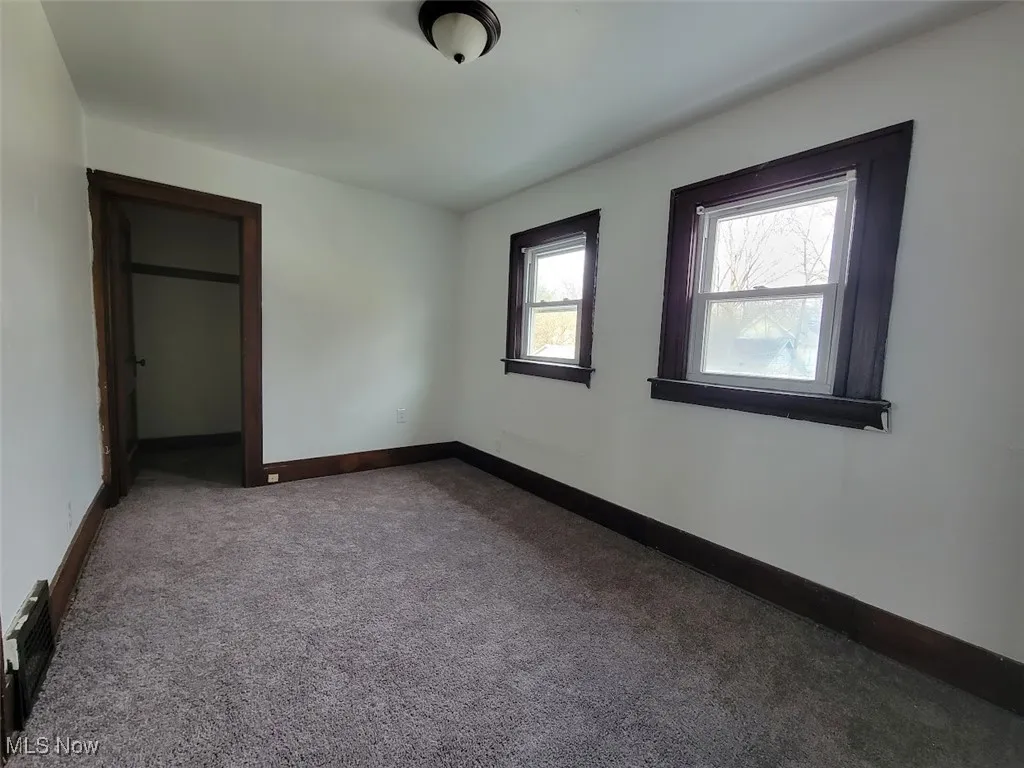 Third bedroom on second floor with carpet flooring.