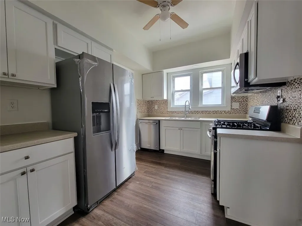 White cabinets, vinyl flooring. Appliances, fridge, gas stove, over range microwave and dishwasher