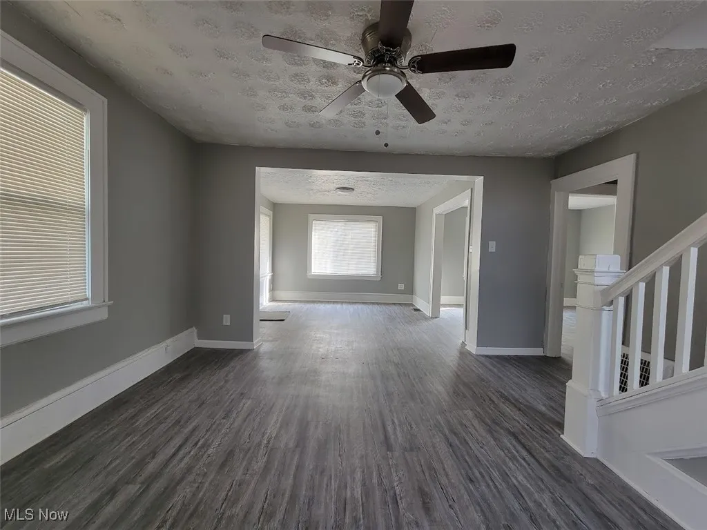 Other side of this large living room with the stair case going upstairs to the 2nd floor.