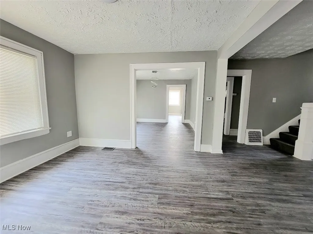 Front living room that flows into dining room or the other side of living room. Vinyl flooring