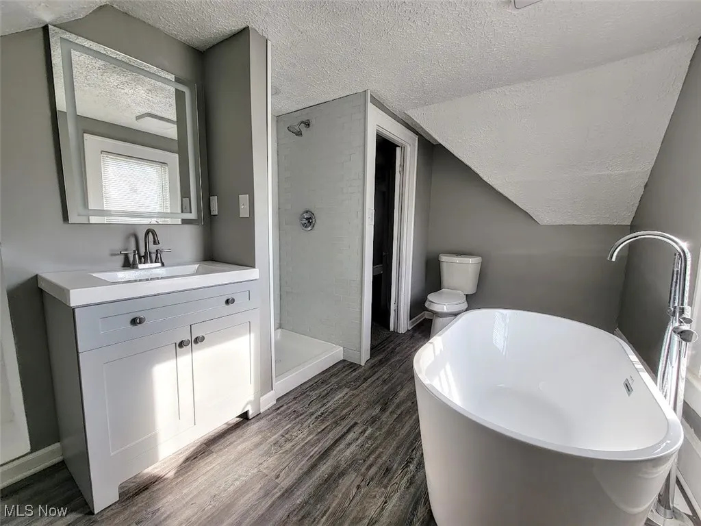 Second floor bathroom with soaker tub, vanity and stand alone shower