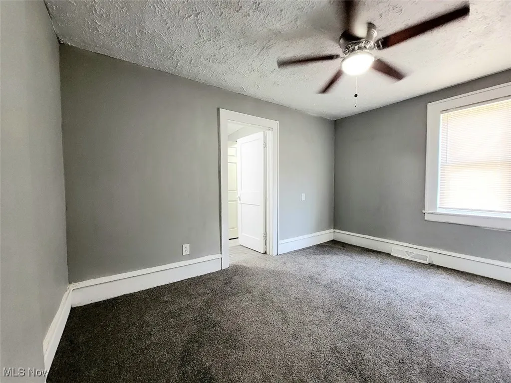 First floor bedroom with an ensuite bathroom. Carpet flooring.