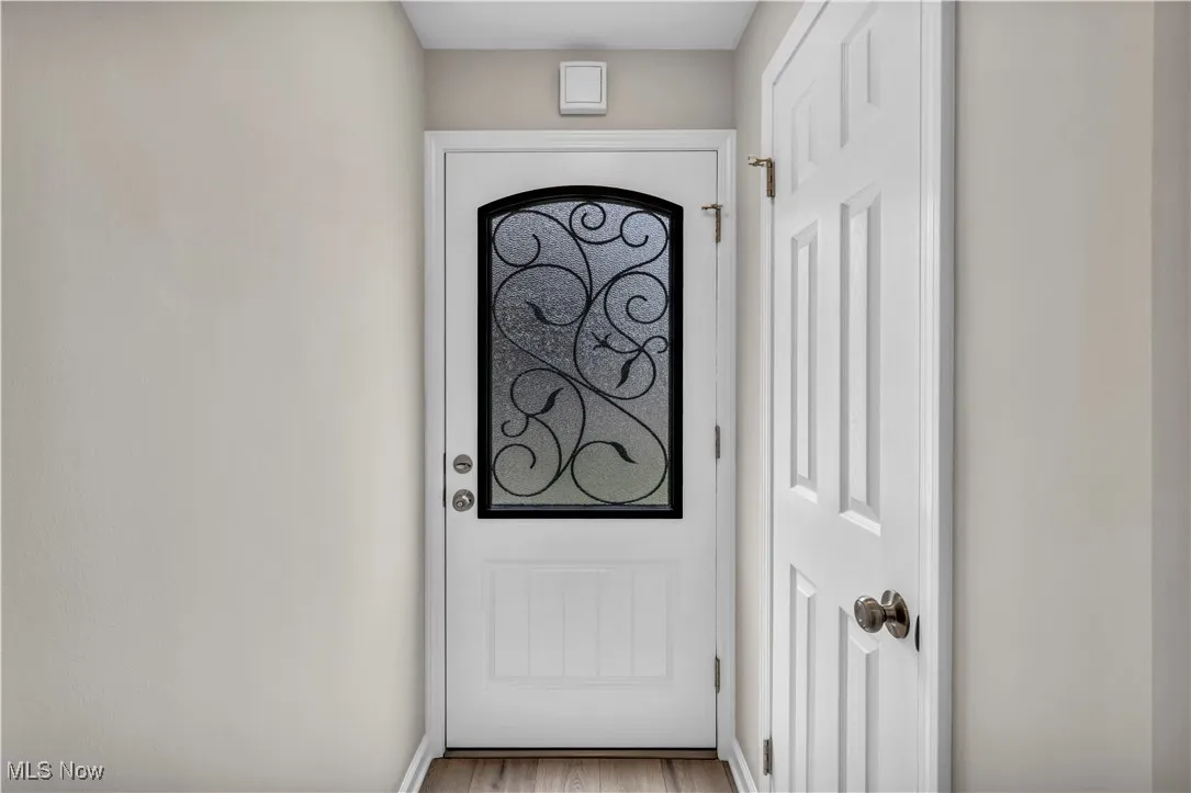 Doorway to outside with wood finished floors