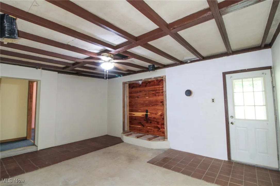 Entryway with beam ceiling and carpet floors