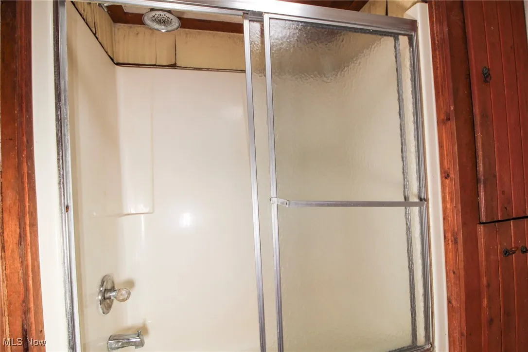 Bathroom with enclosed tub / shower combo
