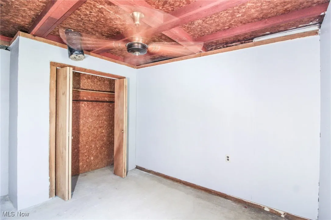 Unfurnished bedroom with concrete floors