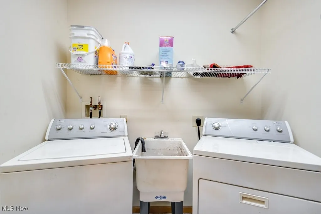 Washroom with washing machine and clothes dryer