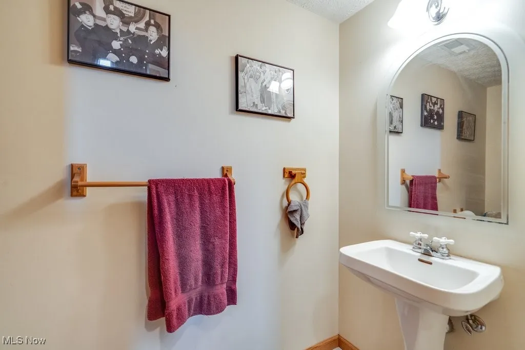 Bathroom with a sink and a textured ceiling
