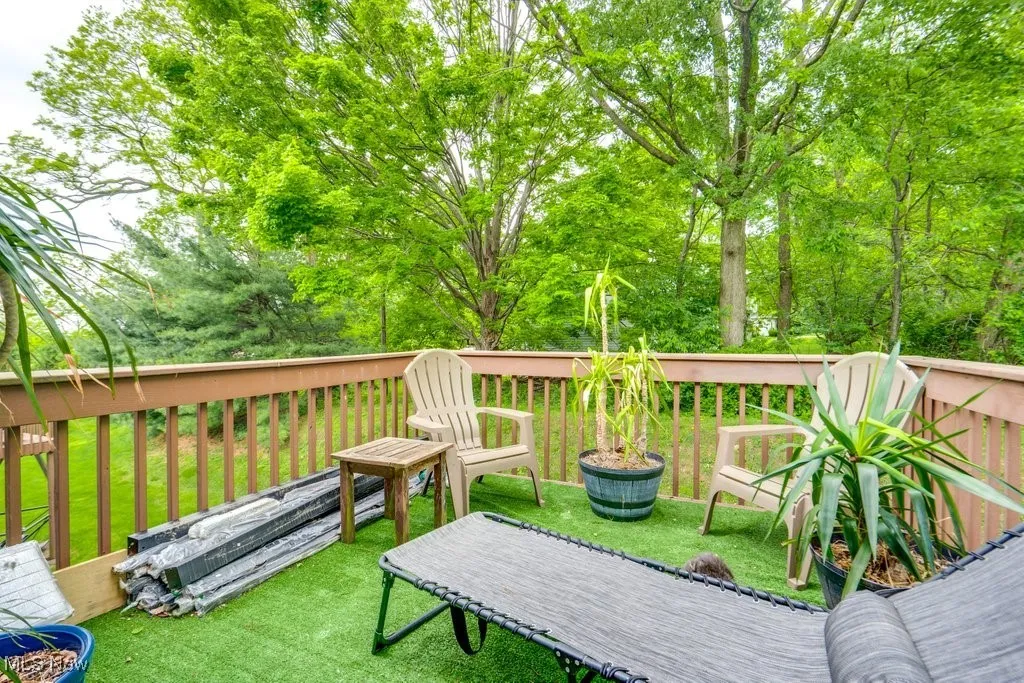 Wooden terrace featuring a yard