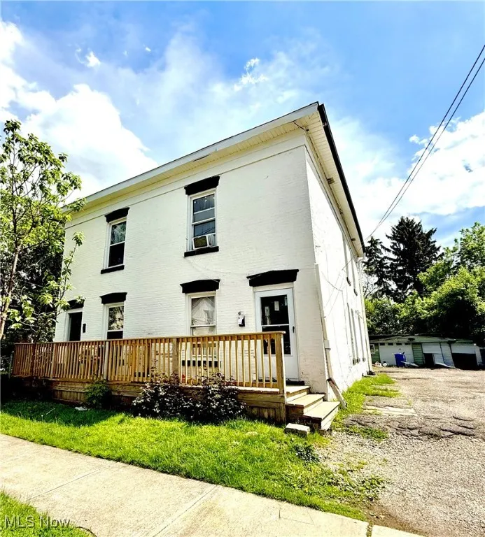 Back of property featuring a wooden deck
