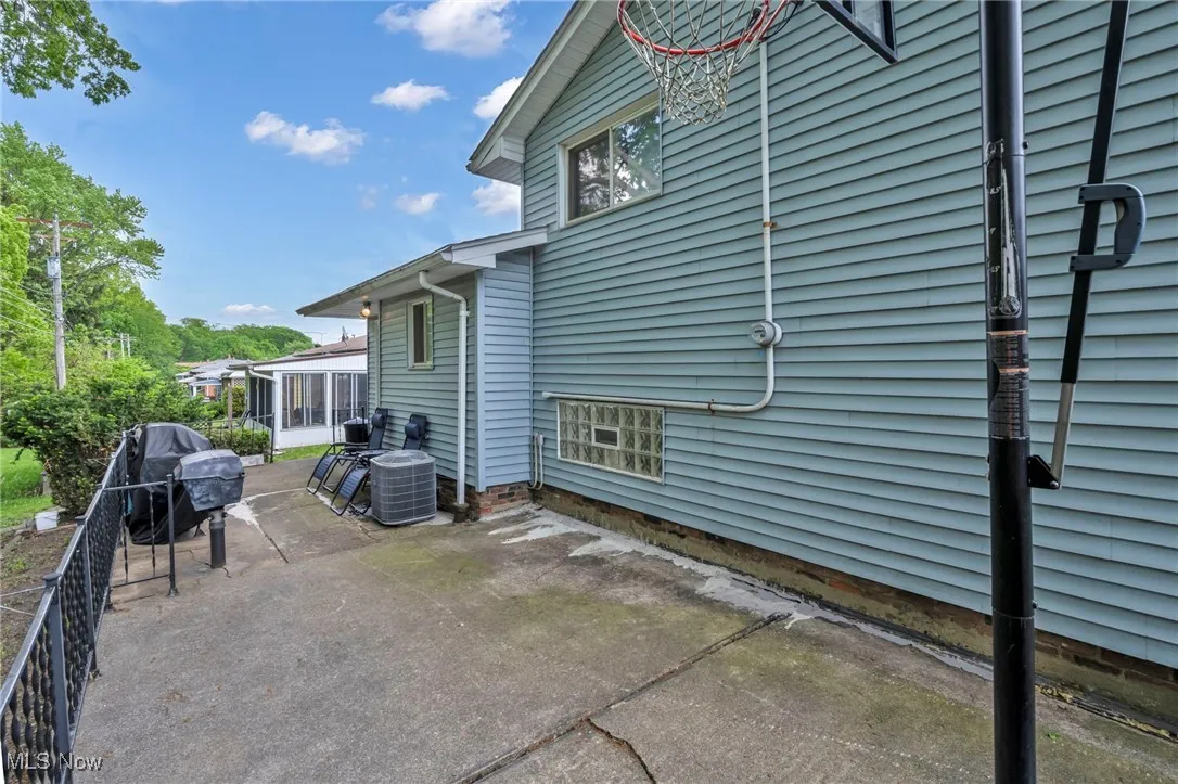 View of patio with a sunroom and central air condition unit
