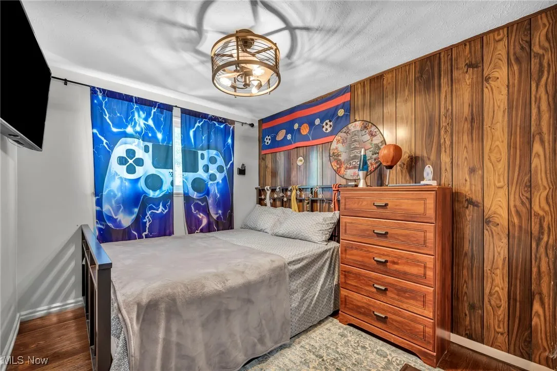 Bedroom featuring wood finished floors and baseboards