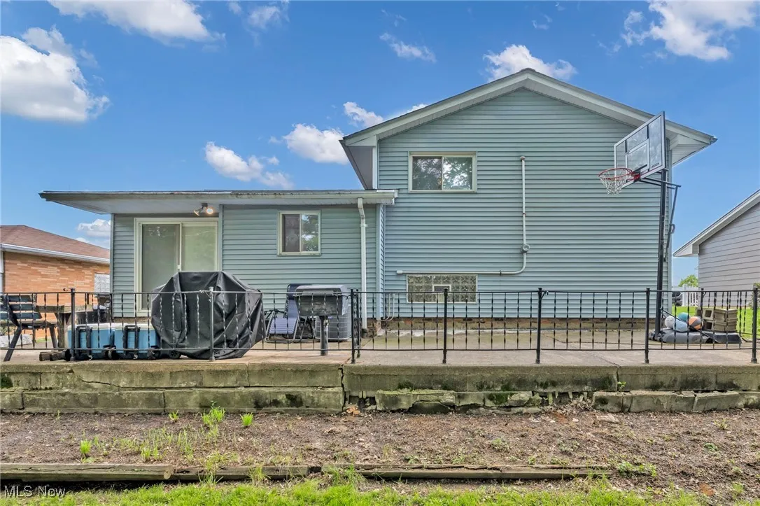 Back of property with a patio area and fence