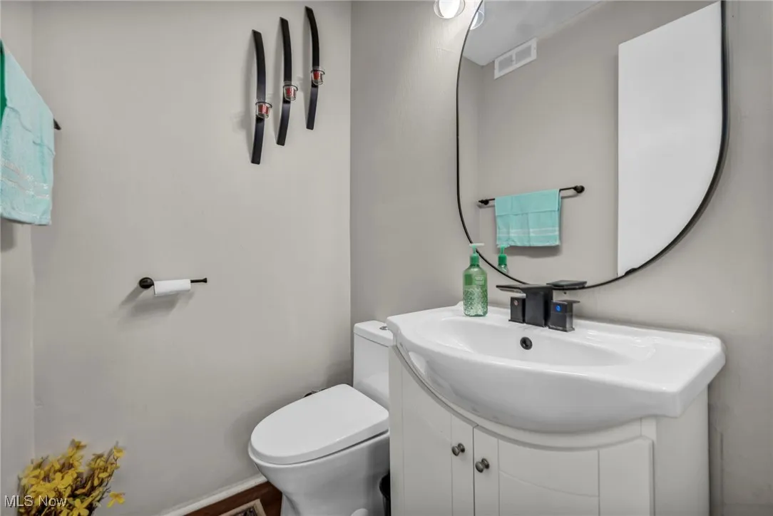 Half bath featuring toilet and vanity