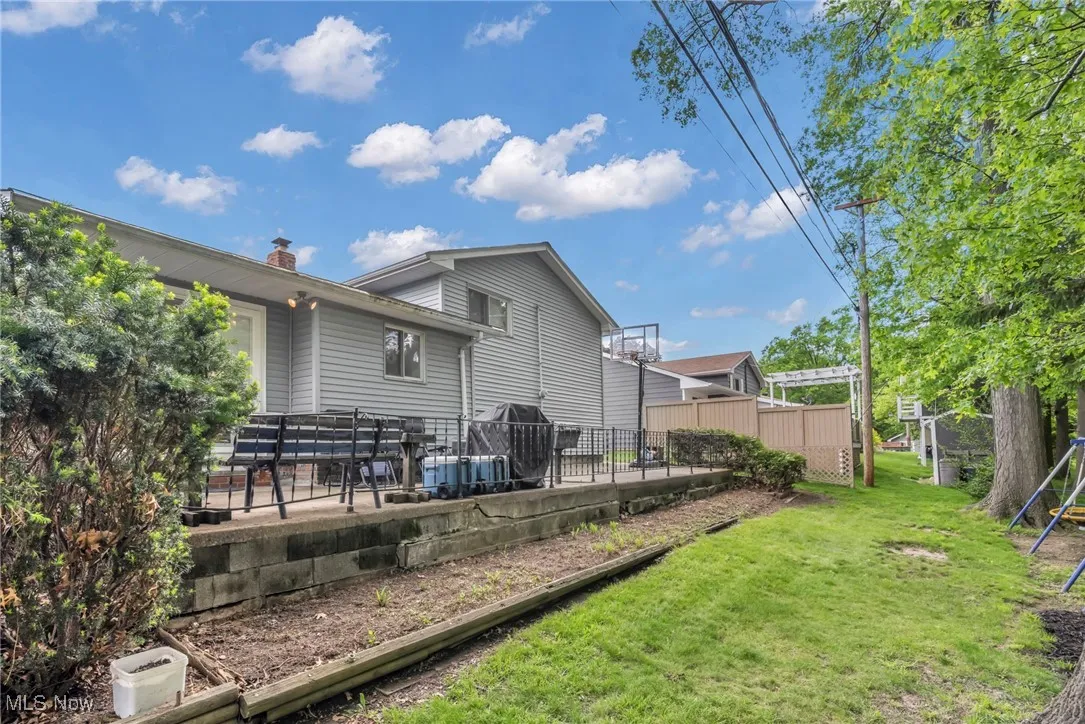 Rear view of house with a patio area and a chimney