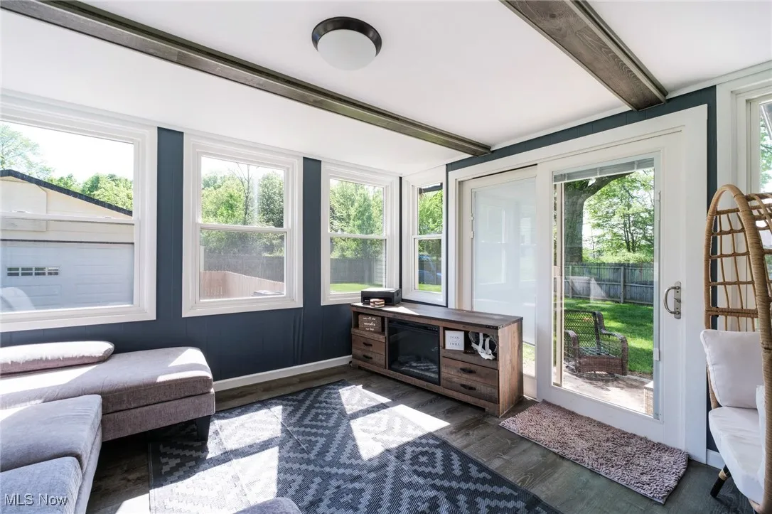 Sunroom / solarium with beamed ceiling