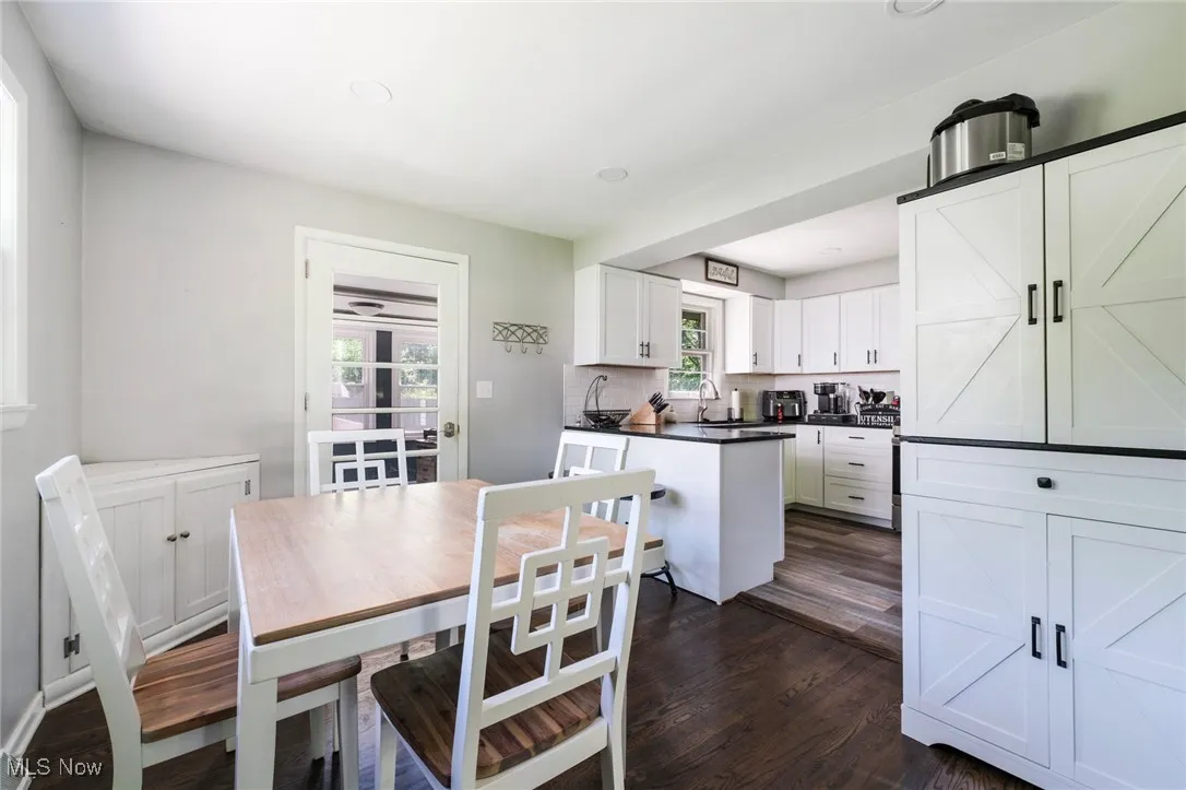 Dining room featuring dark wood-style flooring and recessed lighting
