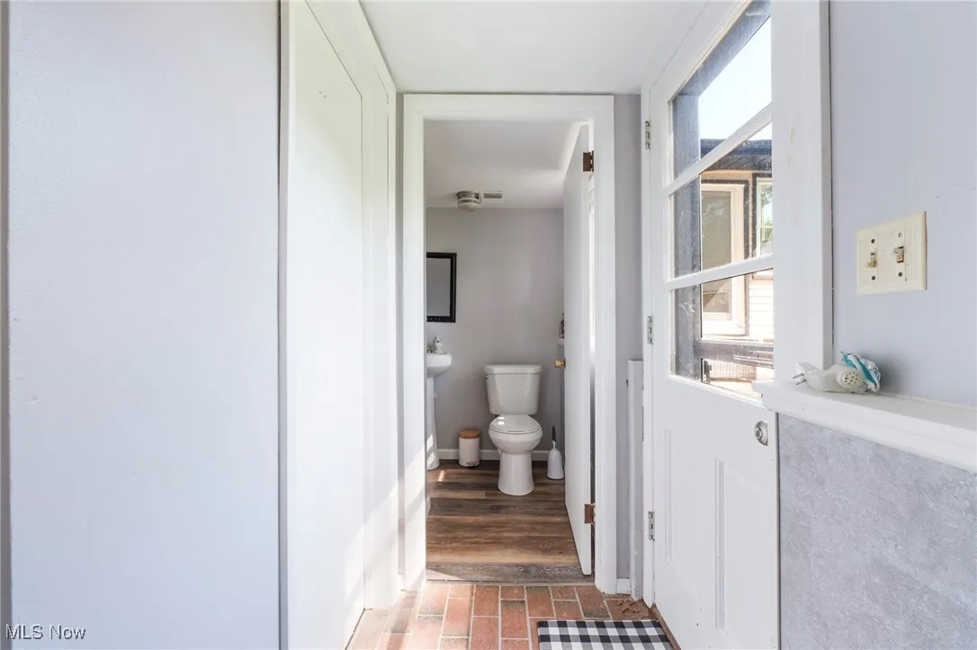 Bathroom with toilet and wood finished floors