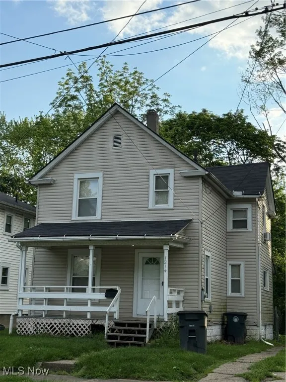 View of front of house featuring a porch and a chimney