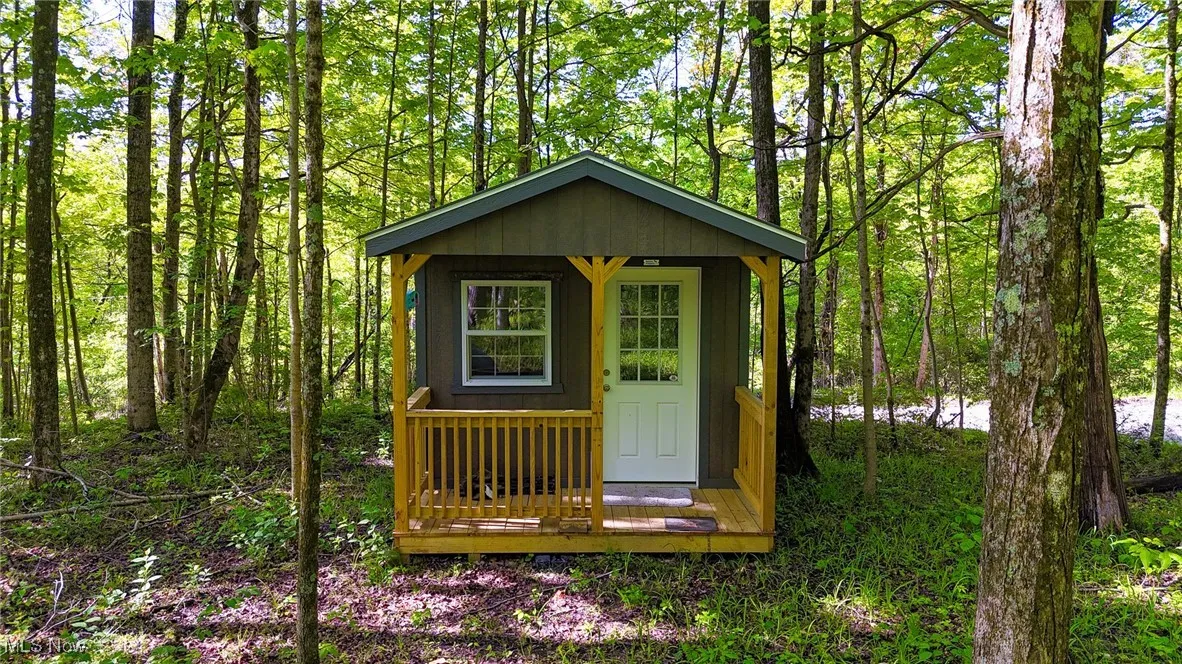 View of outbuilding with an outbuilding and a wooded view