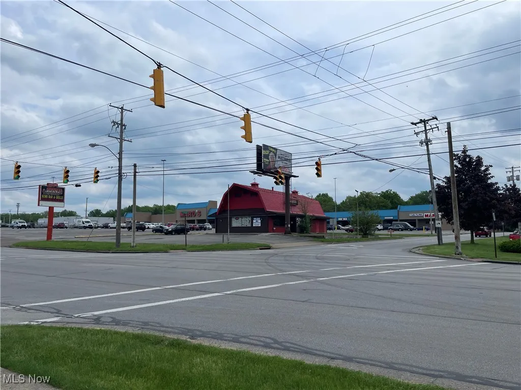 View of asphalt road featuring traffic lights