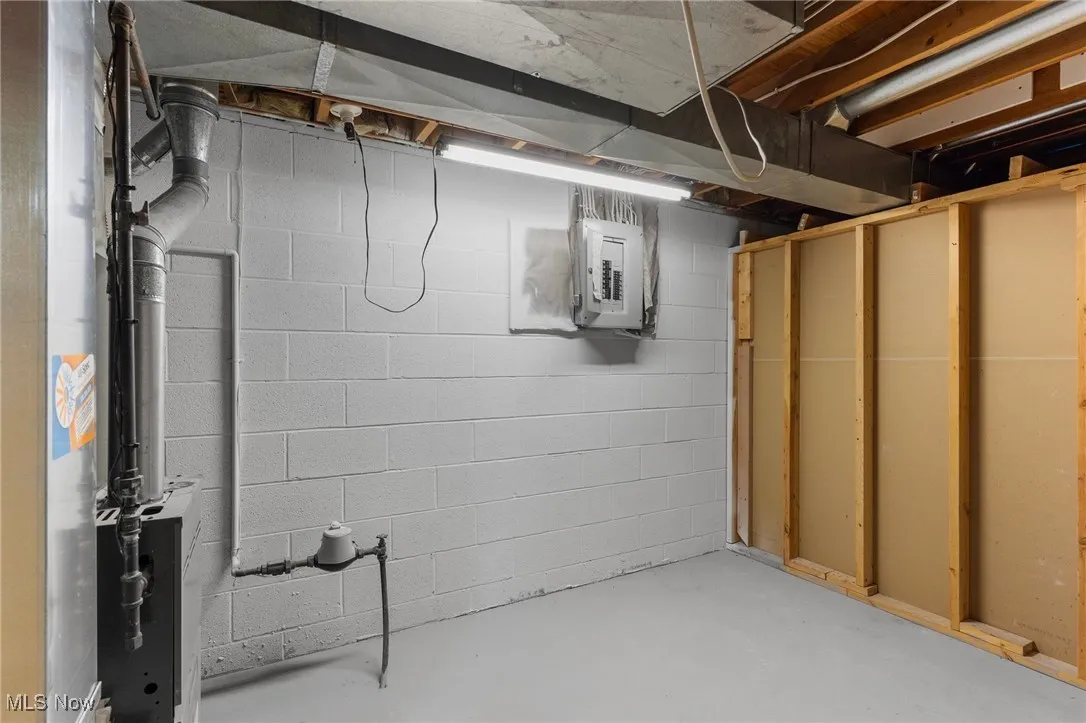 Unfinished basement featuring electric panel
