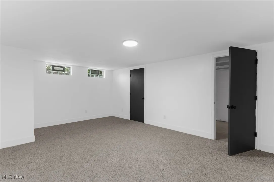 Below grade area featuring carpet floors and baseboards