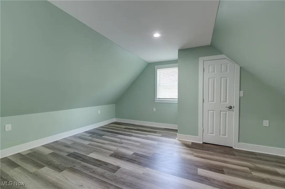 Bonus room featuring vaulted ceiling, wood finished floors, baseboards, and recessed lighting