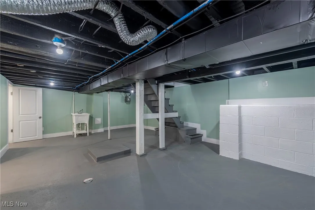 Finished basement featuring stairway and baseboards
