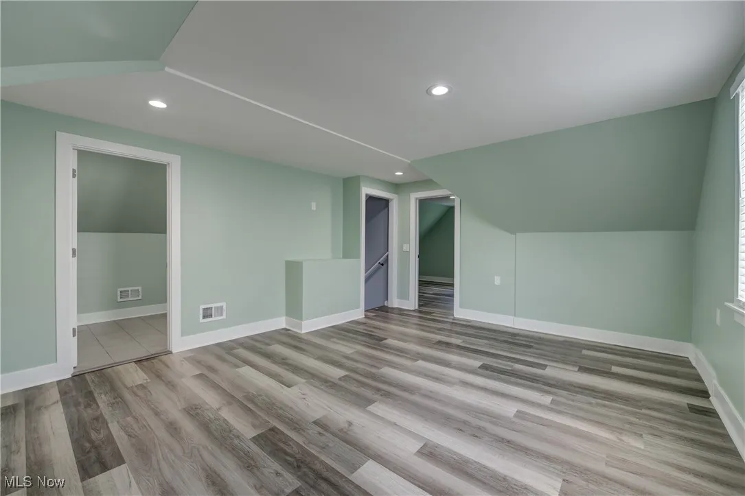 Bonus room featuring recessed lighting, wood finished floors, and baseboards