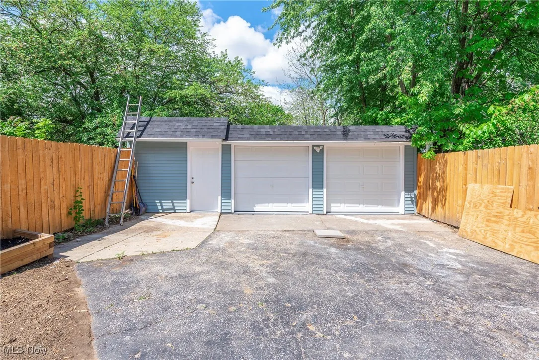 Detached garage featuring fence