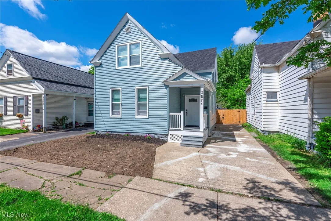 View of front of home featuring driveway and roof with shingles