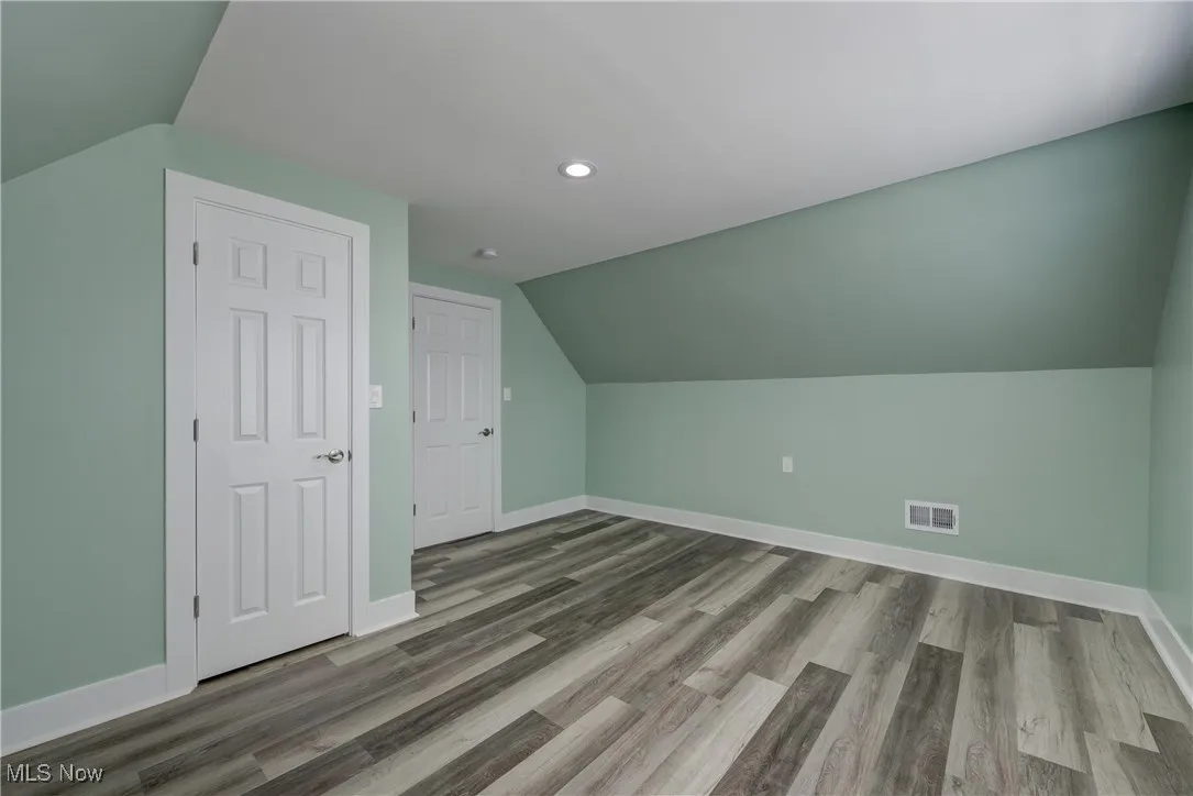 Bonus room with vaulted ceiling, baseboards, recessed lighting, and wood finished floors