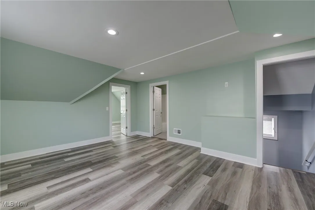 Bonus room featuring wood finished floors, recessed lighting, and baseboards