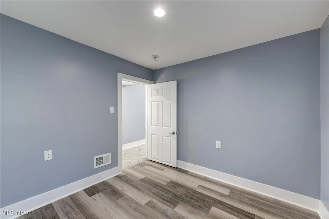 Empty room featuring baseboards and wood finished floors