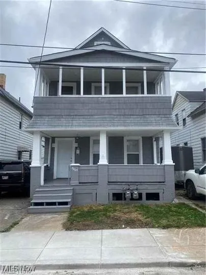 View of front of house with a porch and a balcony