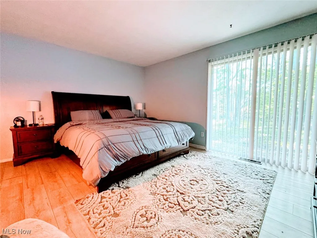 Bedroom with wood finished floors and baseboards