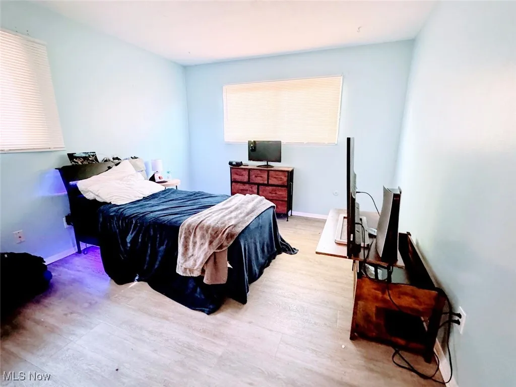 Bedroom with light wood-style floors