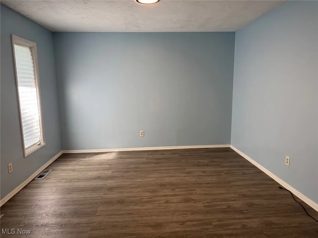 Empty room with wood finished floors and baseboards