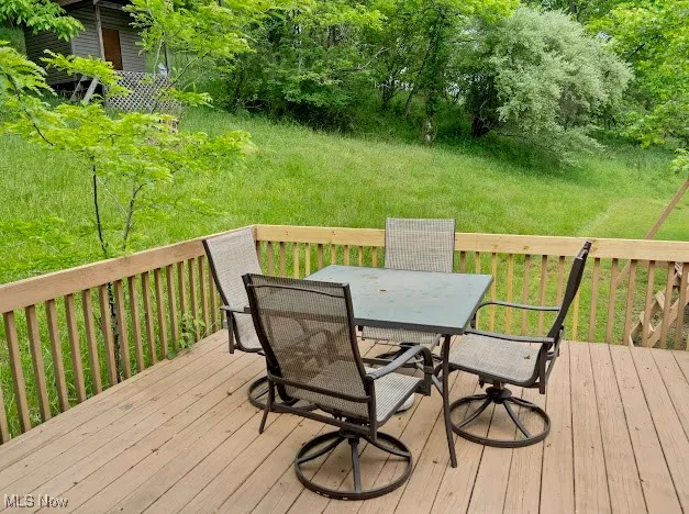 Deck featuring outdoor dining space and central AC